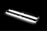 Two long door sill plates with Trafic lettering and edges illuminated in white, angled view on a dark background.