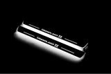 Two long door sill plates with Grandland X lettering and edges illuminated in white, angled view on a dark background.