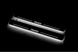 Two long door sill plates with Aveo lettering and edges illuminated in white, angled view on a dark background.
