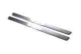 Two long silver-finished door sill plates with Lanos lettering on a light background, angled view.