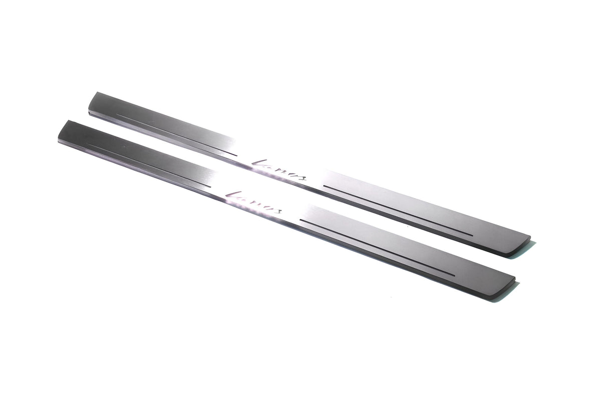 Two long silver-finished door sill plates with Lanos lettering on a light background, angled view.