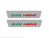 Catalog illustration of two short gray door sill plates with green 345 and red HEMI lettering in one row with horizontal lines on a white background.