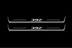 Two long door sill plates with 392 lettering and edges illuminated in white, straight-on view on a dark background.