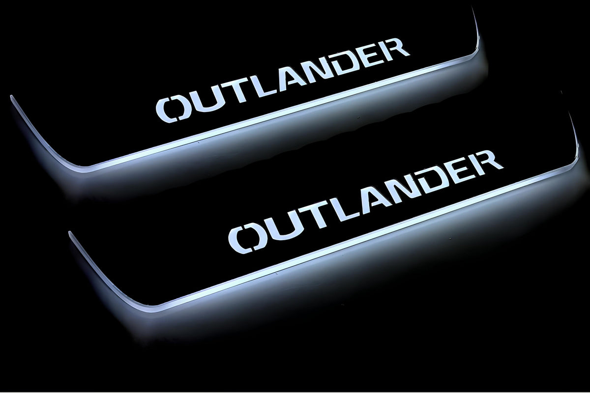 Close-up of Outlander lettering and illuminated edges on door sill plates against a dark background.
