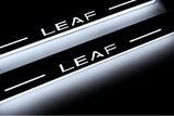 Nissan Leaf I 2010+ entry guards in stainless steel with Leaf logo