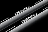 Close-up of Denali lettering and illuminated edges on door sill plates against a dark background.