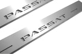 Close-up of Passat lettering and linear slots in silver-finished door sill plates.