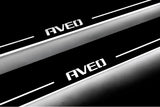 Close-up of Aveo lettering and illuminated edges on door sill plates against a dark background.