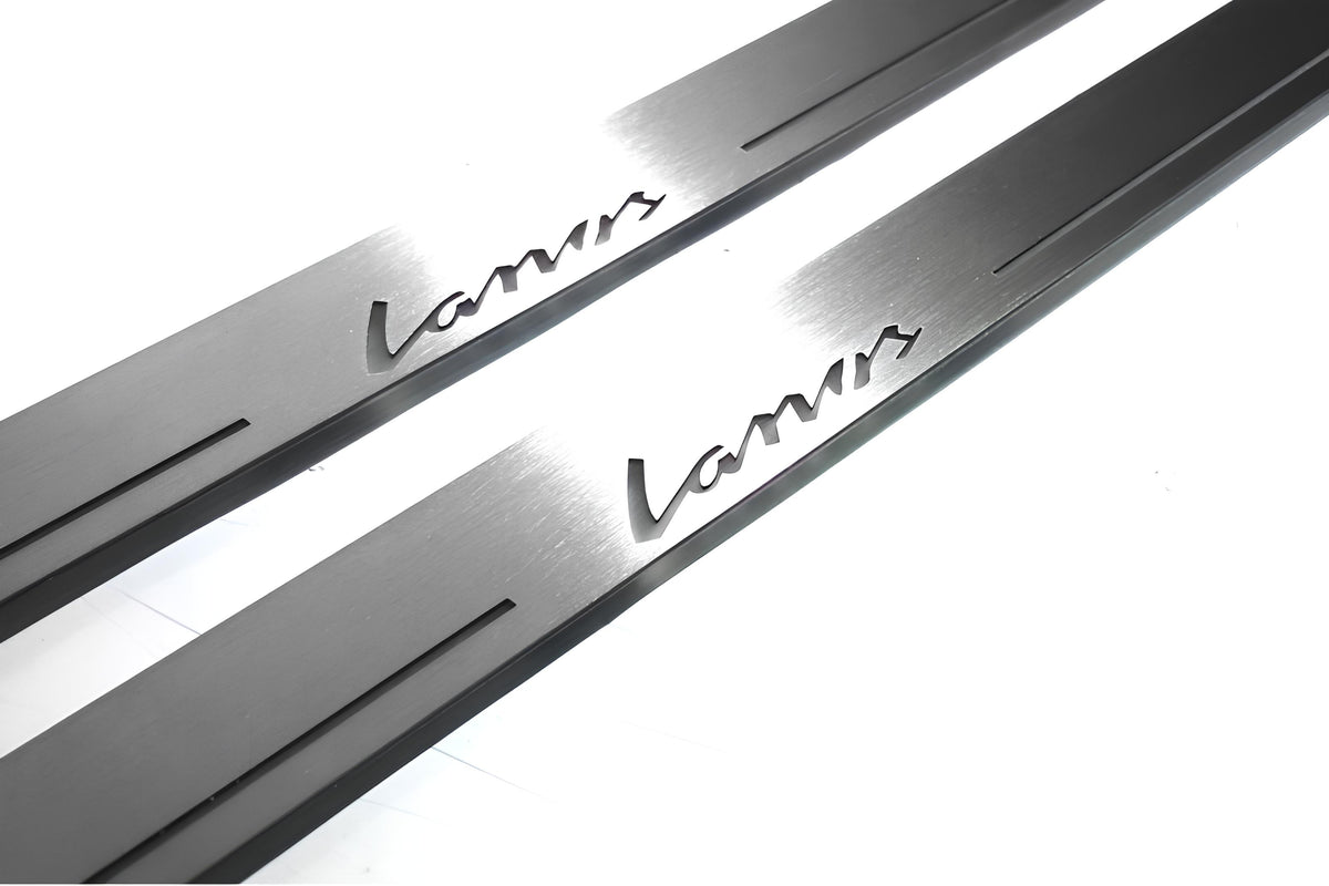 Close-up of Lanos lettering and linear slots in silver-finished door sill plates.