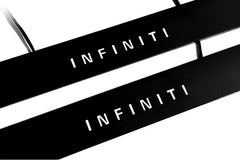 Close-up of black door sill plates with white Infiniti lettering.