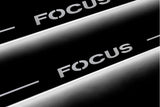 LED door sill plates Ford Focus II 2004+ in stainless steel with Focus logo
