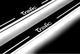 Close-up of Trafic lettering and illuminated edges on door sill plates against a dark background.
