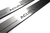 Close-up of Acura lettering and linear slots in silver-finished door sill plates.