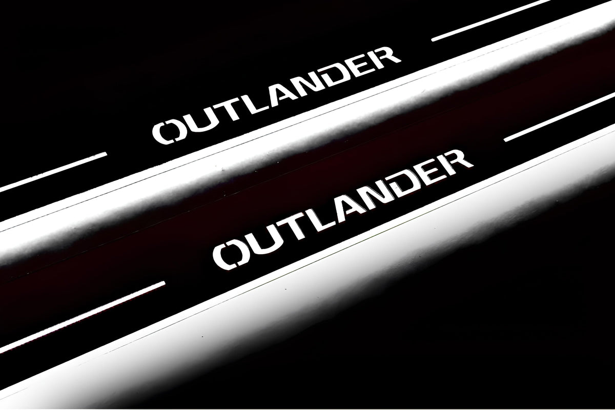 Close-up of Outlander lettering and illuminated edges on door sill plates against a dark background.