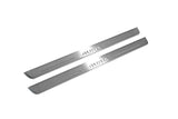 Two long silver-finished door sill plates with Auris lettering on a light background, angled view.