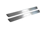 Two long silver-finished door sill plates with Grandland X lettering on a light background, angled view.