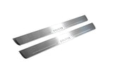 Two long silver-finished door sill plates with Aveo lettering on a light background, angled view.