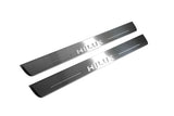 Toyota Hilux VIII 2015+ illuminated entry guards in stainless steel with Hilux logo