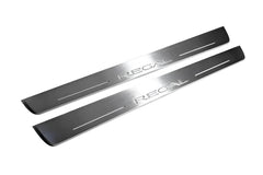 Two long silver-finished door sill plates with Regal lettering on a light background, angled view.