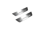 Two short silver-finished door sill plates with Outback lettering on a light background, angled view.