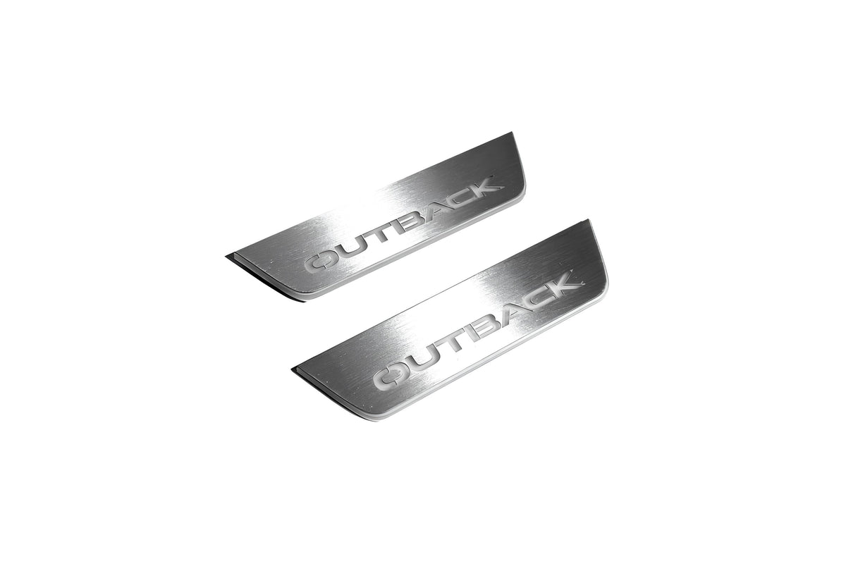 Two short silver-finished door sill plates with Outback lettering on a light background, angled view.