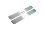 Two short silver-finished door sill plates with MDX lettering on a light background, angled view.