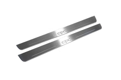 Two long silver-finished door sill plates with OPC lettering on a light background, angled view.