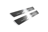 Two short silver-finished door sill plates with A-Spec lettering on a light background, angled view.