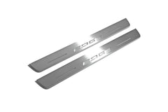 Two long silver-finished door sill plates with Edge lettering on a light background, angled view.