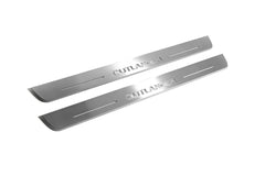 Two long silver-finished door sill plates with Outlander lettering on a light background, angled view.