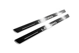 Two long silver-finished door sill plates with Levorg lettering on a light background, angled view.