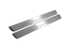 Two long silver-finished door sill plates with Cayenne lettering on a light background, angled view.