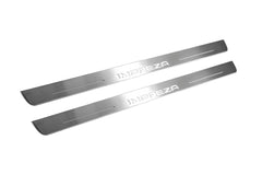 Two long silver-finished door sill plates with Impreza lettering on a light background, angled view.