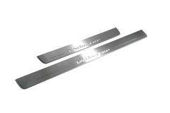 Two unequal-length silver-finished door sill plates with Veloster lettering on a light background, angled view.
