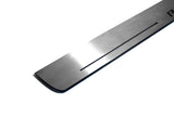 Close-up of a rounded silver door sill corner and long linear slot.