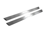 Two long silver-finished door sill plates with Outback lettering on a light background, angled view.