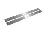 Two long silver-finished door sill plates with H2 lettering on a light background, angled view.