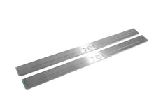 Two long silver-finished door sill plates with H2 lettering on a light background, angled view.
