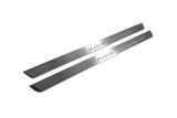 Two long silver-finished door sill plates with Juke lettering on a light background, angled view.