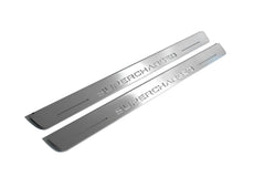 Two long silver-finished door sill plates with Supercharged lettering on a light background, angled view.