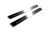 Two long reflective dark door sill plates with white Acura lettering and horizontal lines on a white background, angled view.