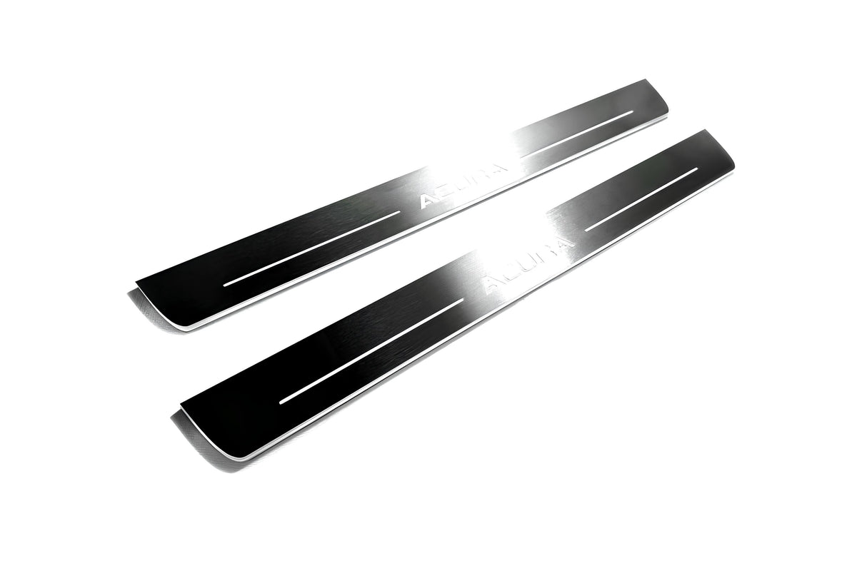 Two long reflective dark door sill plates with white Acura lettering and horizontal lines on a white background, angled view.