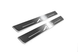 Two long silver-finished door sill plates with A-Spec lettering on a light background, angled view.