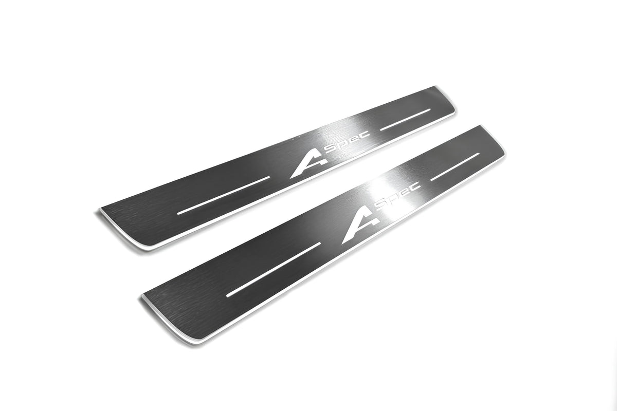 Two long silver-finished door sill plates with A-Spec lettering on a light background, angled view.