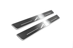 Two long silver-finished door sill plates with A-Spec lettering on a light background, angled view.