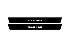 Catalog illustration of two black front door sill plates with Alpina lettering.