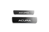 Two short reflective dark door sill plates with white Acura lettering on a white background, straight-on view.