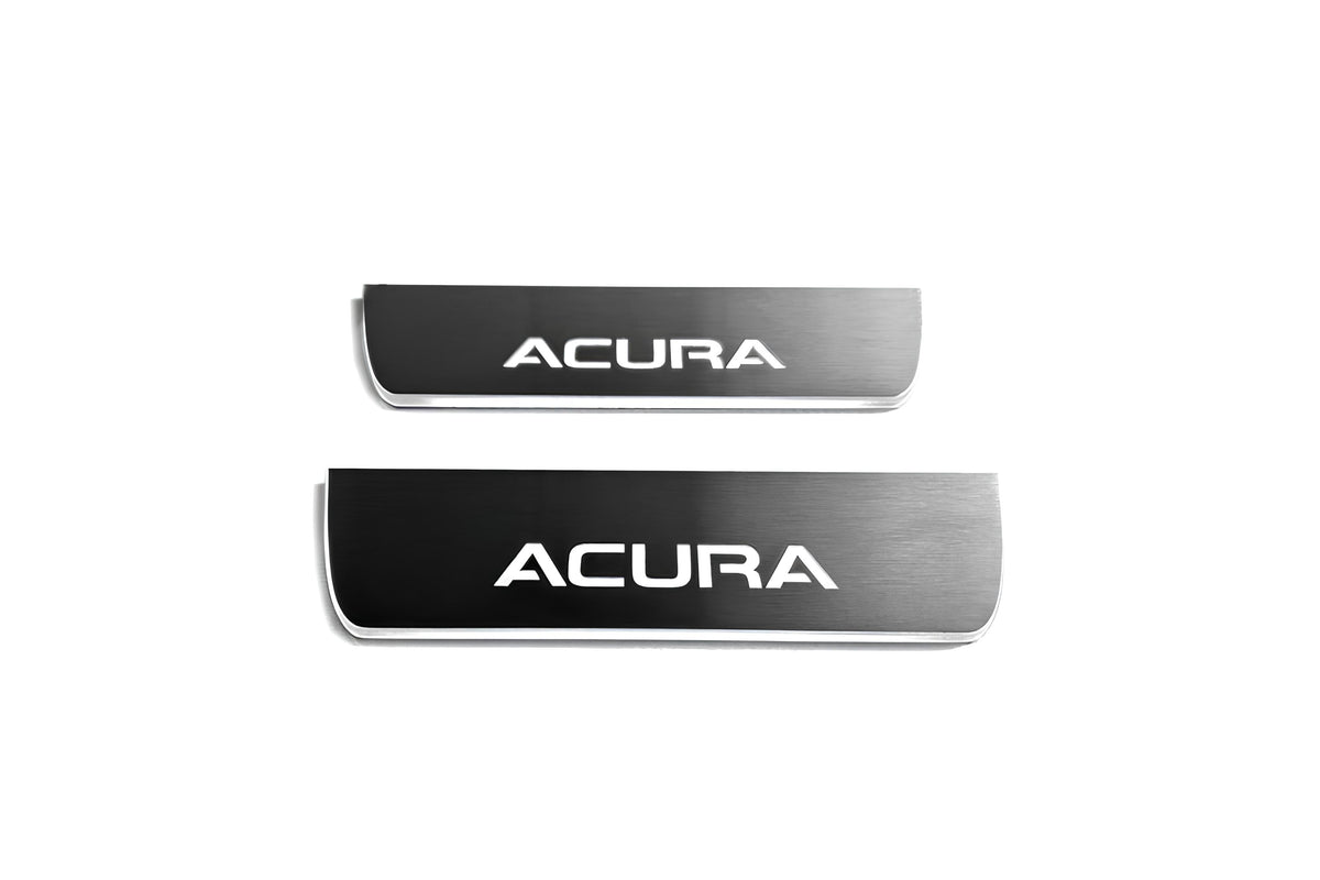Two short reflective dark door sill plates with white Acura lettering on a white background, straight-on view.
