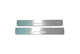 Two short silver-finished door sill plates with MDX lettering on a light background, straight-on view.