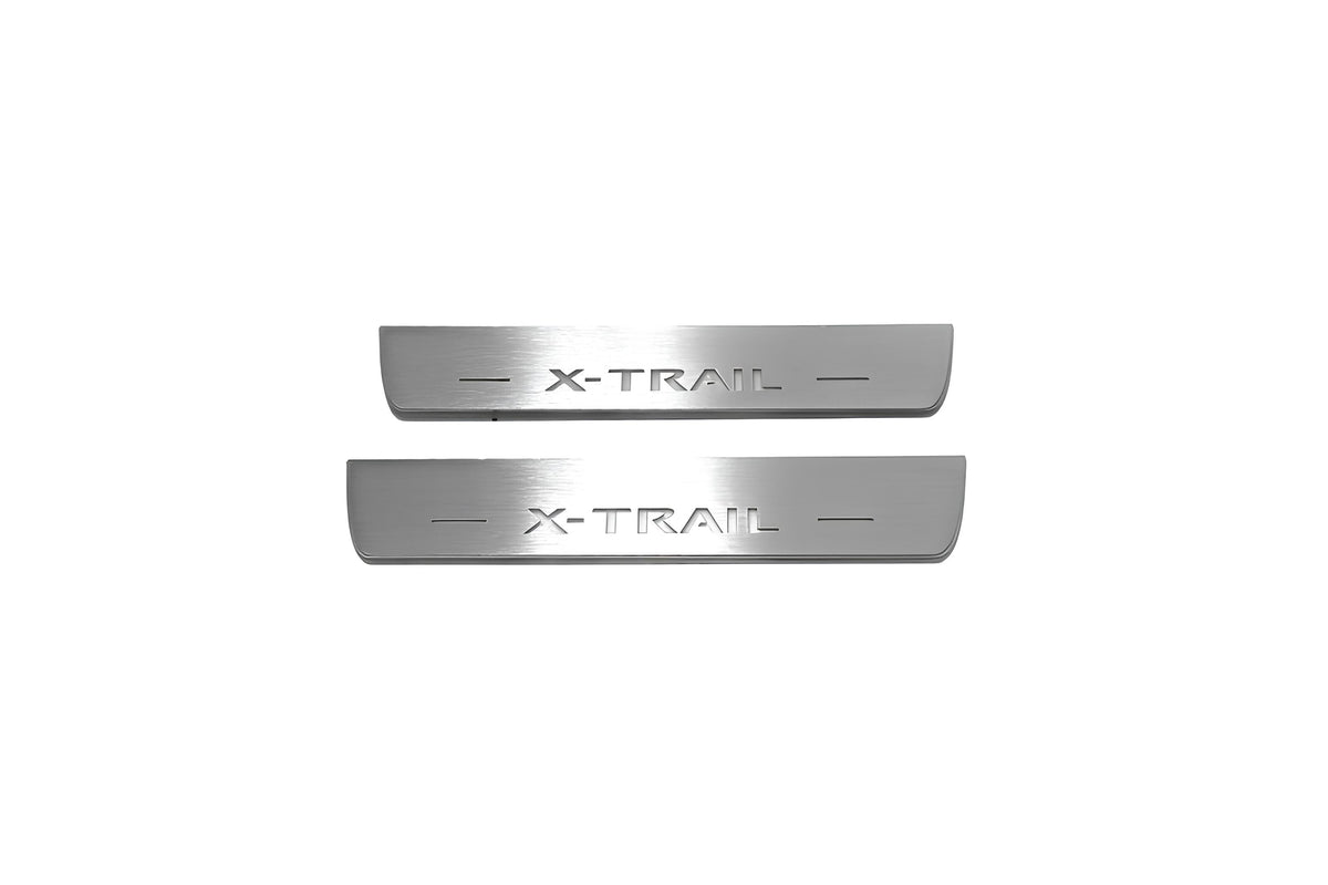Two short silver-finished door sill plates with X-Trail lettering on a light background, straight-on view.